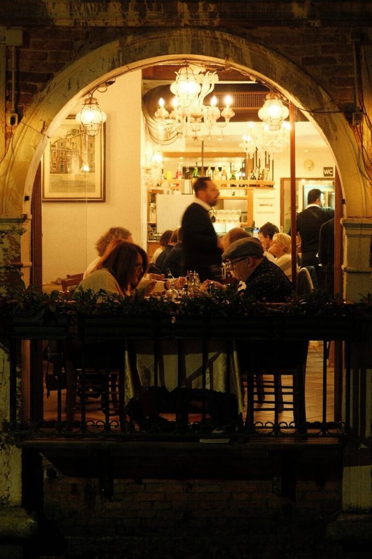 Warm ambiance of an Italian restaurant with people enjoying dinner under soft lighting.